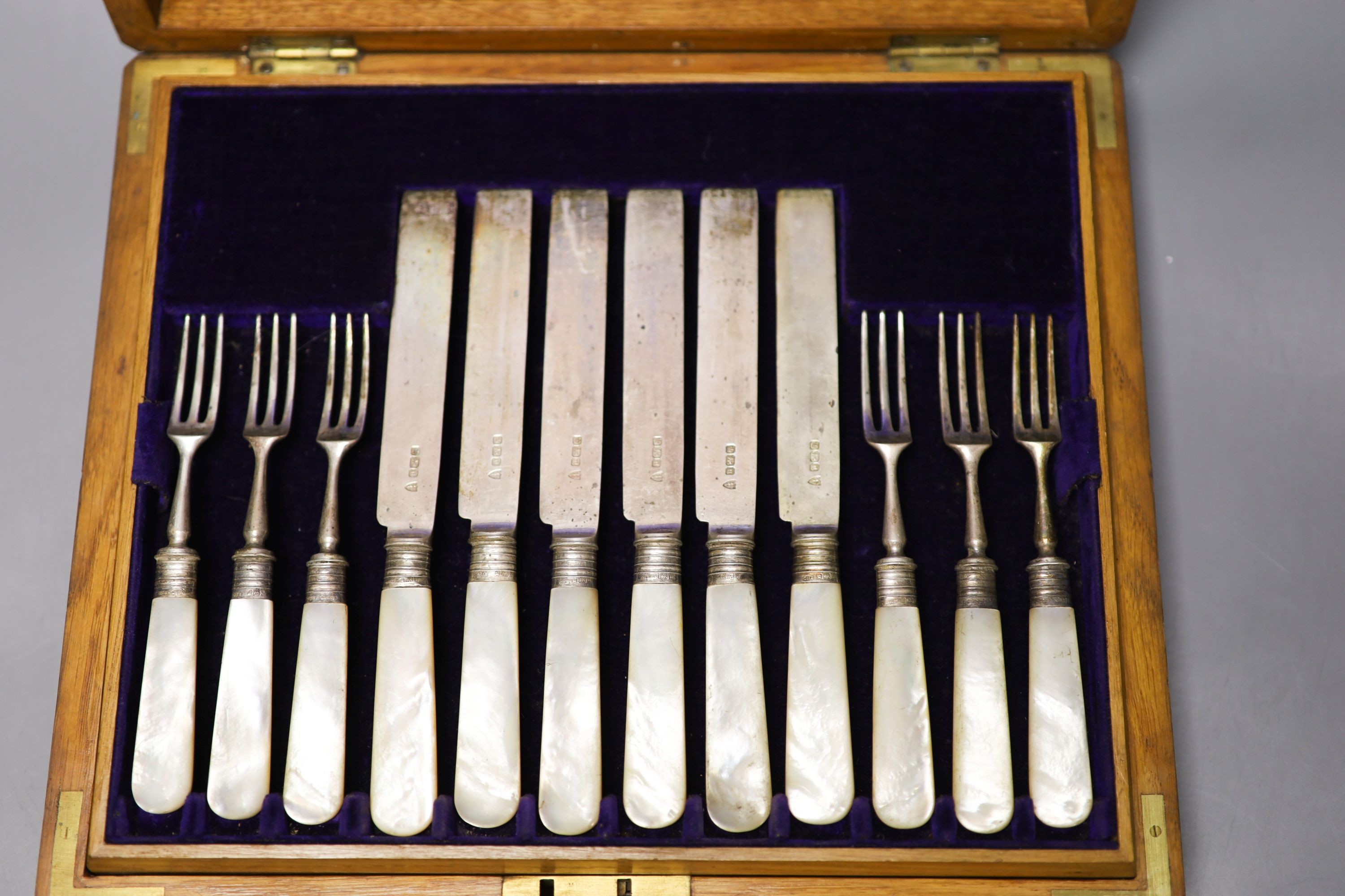 A George V cased set of six pairs of mother of pearl handled silver dessert eaters, Sheffield, 1912 and a plated part set.